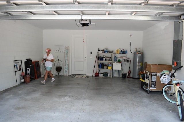2735 Lavandula Ct, North Port, FL 34289 - garage featuring a garage door opener, concrete block wall, and electric water heater