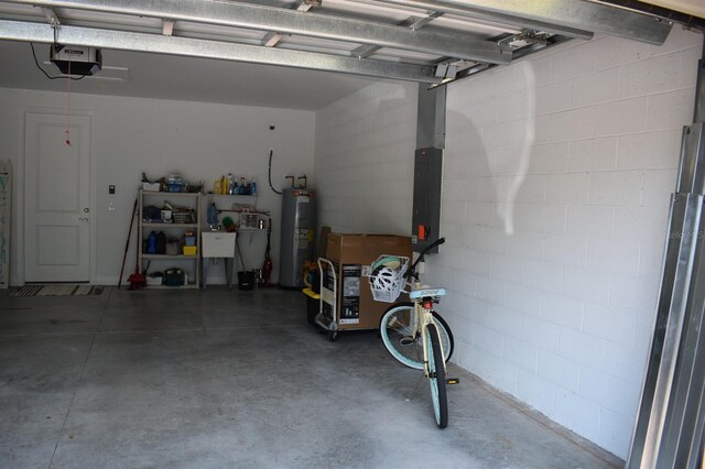 2735 Lavandula Ct, North Port, FL 34289 - garage with water heater, concrete block wall, and a garage door opener