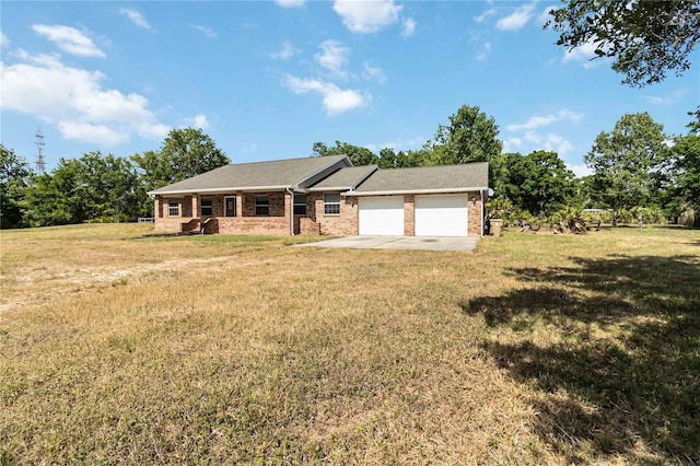 ranch-style home with brick siding, a garage, a front yard, and concrete driveway