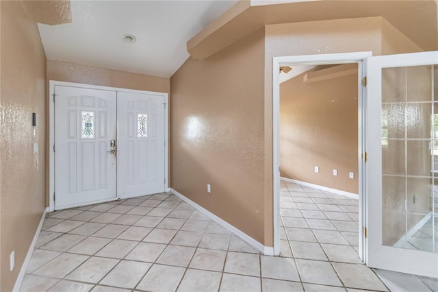 entrance foyer featuring light tile patterned floors and baseboards