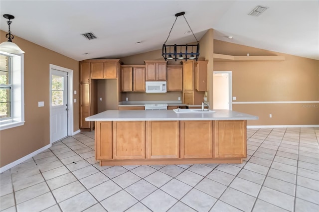 kitchen featuring a sink, light countertops, vaulted ceiling, white microwave, and visible vents