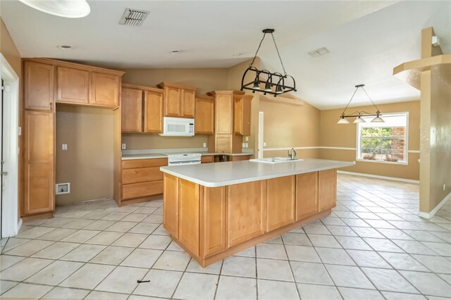 kitchen with a sink, visible vents, light countertops, white appliances, and vaulted ceiling