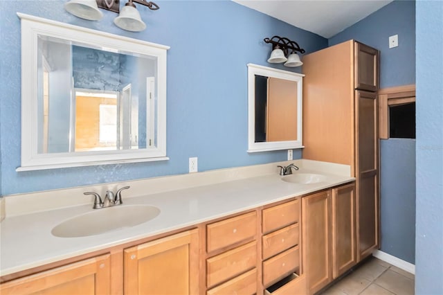 full bath featuring tile patterned flooring, a sink, and double vanity