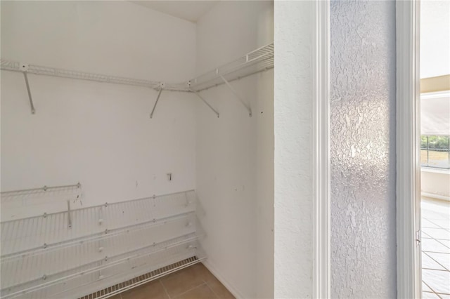 spacious closet featuring tile patterned floors
