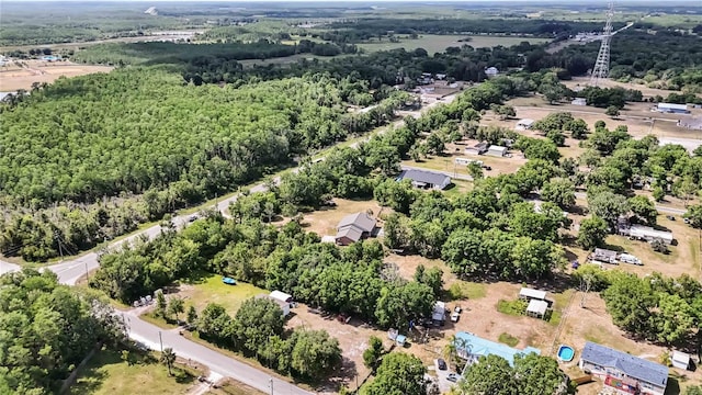 birds eye view of property with a view of trees