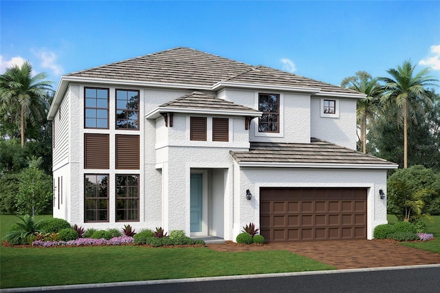view of front of home featuring decorative driveway, a garage, stucco siding, and a front yard