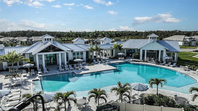 pool with a residential view, fence, a patio, and french doors