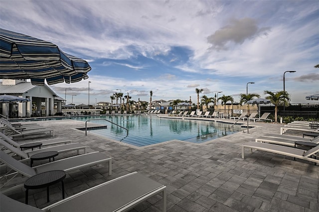 pool with fence and a patio area