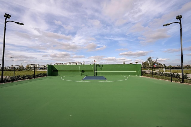 view of basketball court with community basketball court and fence