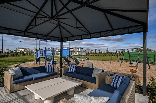 view of patio / terrace featuring a gazebo, an outdoor living space, and playground community