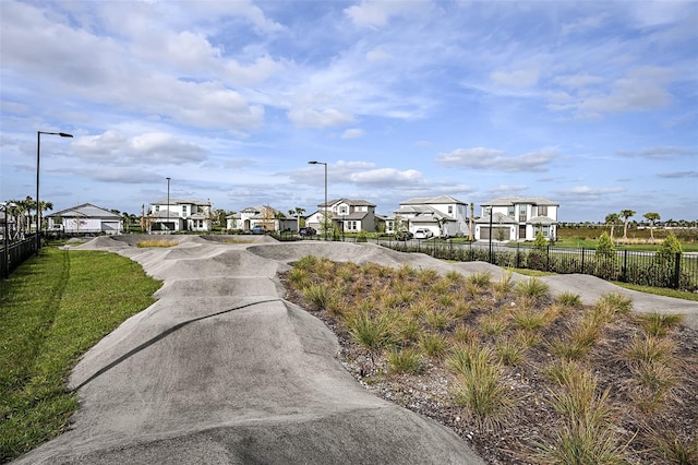 view of road featuring a residential view, driveway, and street lights