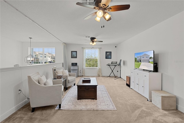 1940 Bell Creek Loop, Fruitland Park, FL 34731 - living area featuring light colored carpet, ceiling fan, a chandelier, and baseboards