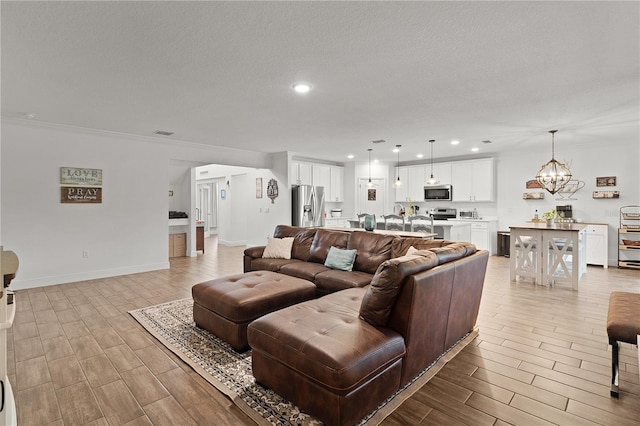 1940 Bell Creek Loop, Fruitland Park, FL 34731 - living room featuring wood tiled floors, a chandelier, recessed lighting, baseboards, and ornamental molding