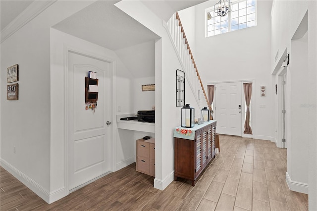 1940 Bell Creek Loop, Fruitland Park, FL 34731 - foyer with light wood finished floors, baseboards, a chandelier, and stairway