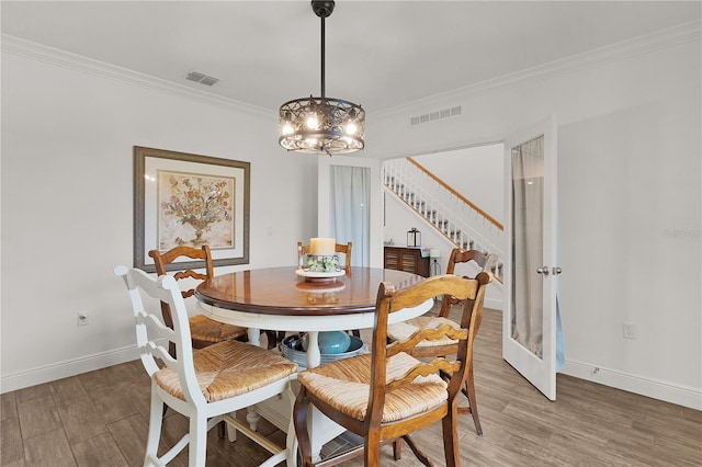 1940 Bell Creek Loop, Fruitland Park, FL 34731 - dining room featuring stairway, a chandelier, ornamental molding, light wood-type flooring, and baseboards