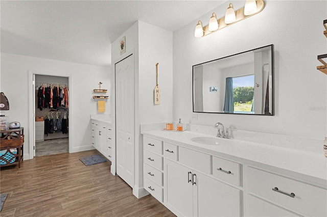 1940 Bell Creek Loop, Fruitland Park, FL 34731 - full bath with vanity, wood finished floors, and a walk in closet