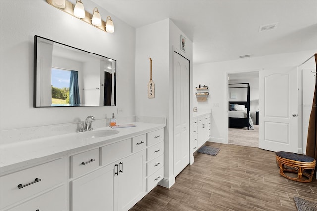 1940 Bell Creek Loop, Fruitland Park, FL 34731 - ensuite bathroom featuring vanity and wood finished floors