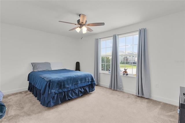 1940 Bell Creek Loop, Fruitland Park, FL 34731 - bedroom with light carpet, baseboards, and ceiling fan