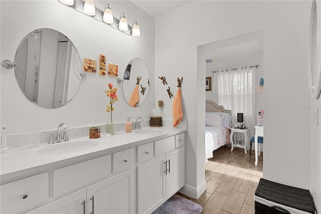 1940 Bell Creek Loop, Fruitland Park, FL 34731 - ensuite bathroom with double vanity and wood finished floors