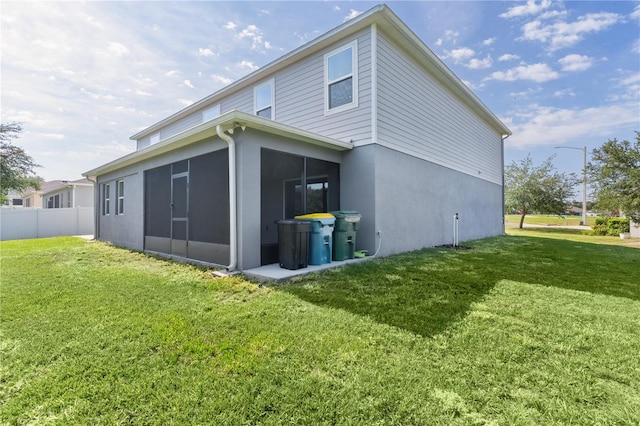 1940 Bell Creek Loop, Fruitland Park, FL 34731 - rear view of house with a sunroom and stucco siding