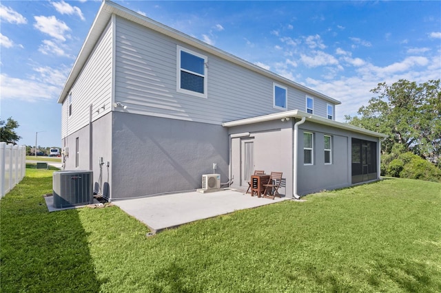 1940 Bell Creek Loop, Fruitland Park, FL 34731 - back of house with central AC, a patio area, a lawn, and stucco siding
