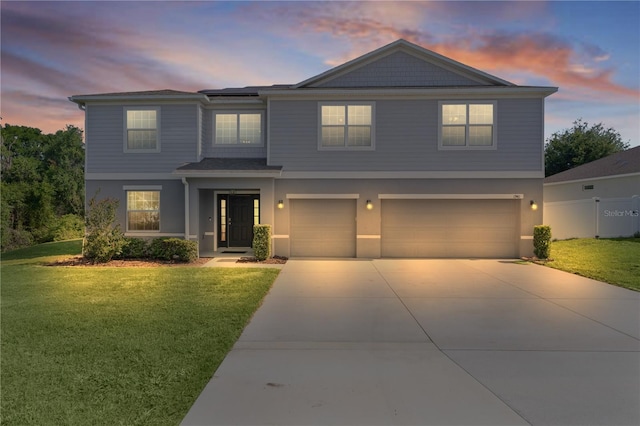 1940 Bell Creek Loop, Fruitland Park, FL 34731 - view of front of home featuring an attached garage, a yard, concrete driveway, solar panels, and stucco siding