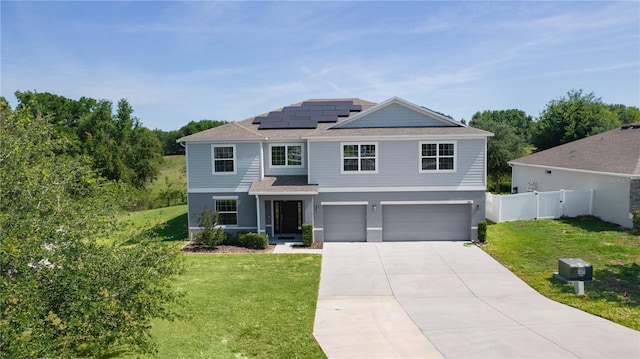 1940 Bell Creek Loop, Fruitland Park, FL 34731 - view of front facade with an attached garage, roof mounted solar panels, driveway, a shingled roof, and stucco siding