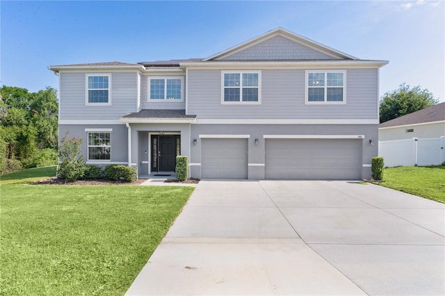 1940 Bell Creek Loop, Fruitland Park, FL 34731 - view of front of house with a garage, roof mounted solar panels, concrete driveway, and stucco siding