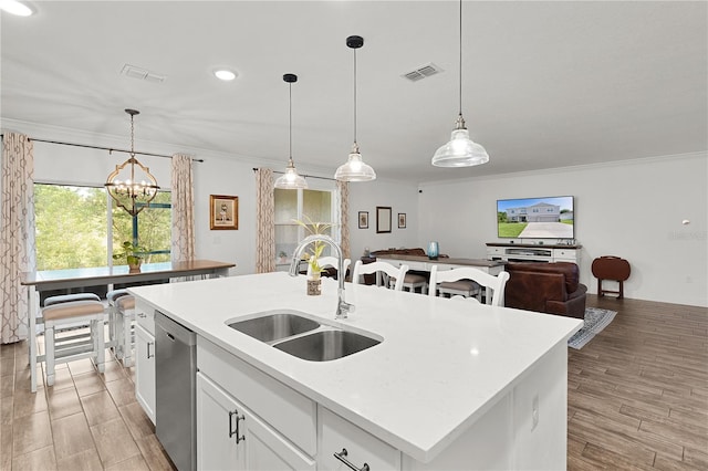 1940 Bell Creek Loop, Fruitland Park, FL 34731 - kitchen with a sink, stainless steel dishwasher, crown molding, a chandelier, and an island with sink
