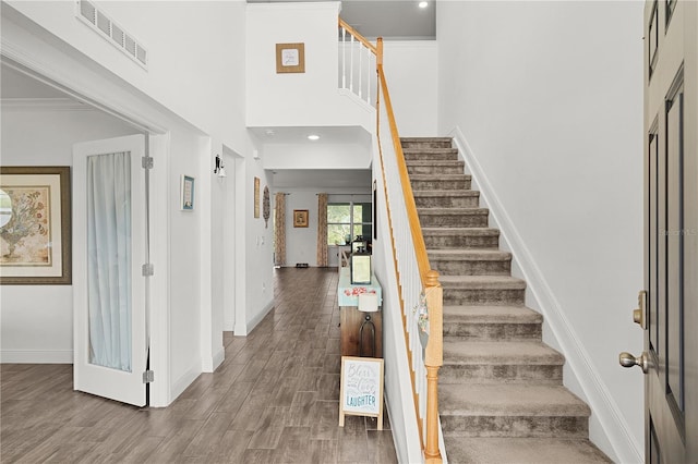 1940 Bell Creek Loop, Fruitland Park, FL 34731 - entryway with stairs, baseboards, wood finished floors, and a towering ceiling