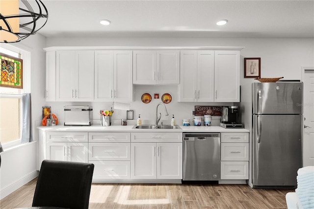 1940 Bell Creek Loop, Fruitland Park, FL 34731 - kitchen featuring stainless steel appliances, a sink, white cabinets, light countertops, and recessed lighting