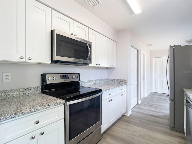 kitchen featuring white cabinetry, light wood-style floors, visible vents, and appliances with stainless steel finishes