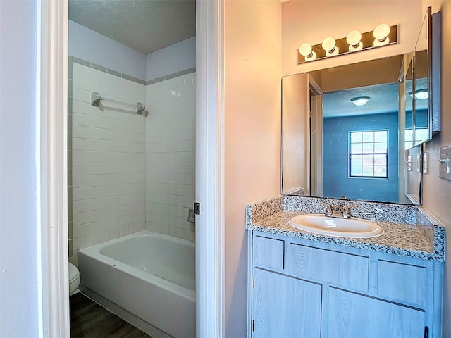 full bathroom with vanity, toilet, shower / bathtub combination, and wood finished floors