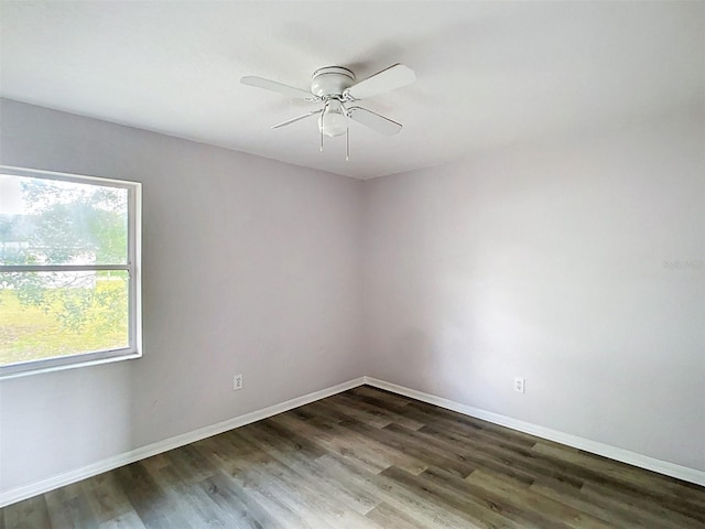 unfurnished room with ceiling fan, baseboards, and wood finished floors