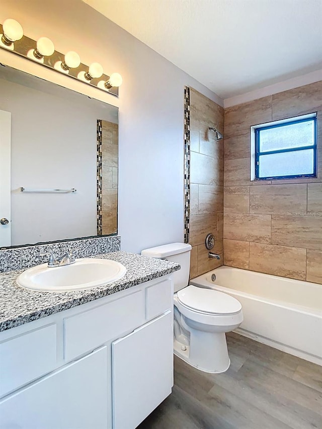 full bathroom with toilet, bathing tub / shower combination, vanity, and wood finished floors