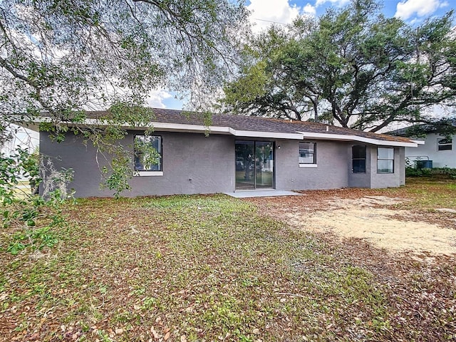 rear view of house with stucco siding
