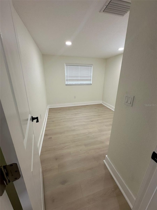 2217 Azalea Ct, Lakeland, FL 33815 - unfurnished room with baseboards, wood finished floors, and recessed lighting