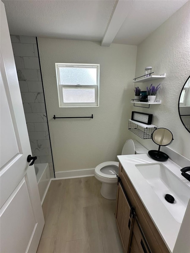 2217 Azalea Ct, Lakeland, FL 33815 - bathroom with toilet, vanity, wood finished floors, baseboards, and a textured wall