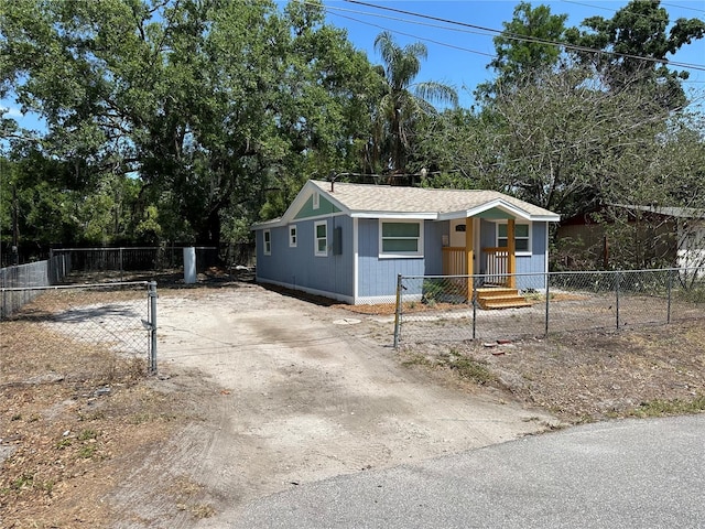 2217 Azalea Ct, Lakeland, FL 33815 - view of front of property featuring driveway, a fenced front yard, and view of scattered trees