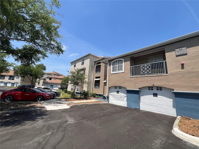 7320 Westpointe Blvd Unit 531, Orlando, FL 32835 - view of property featuring an attached garage and driveway