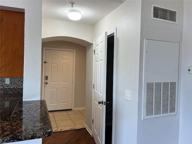 7320 Westpointe Blvd Unit 531, Orlando, FL 32835 - hallway with arched walkways and dark wood-style flooring