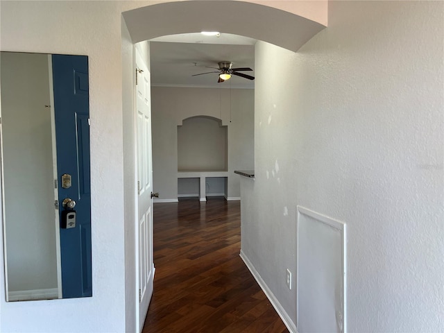 7320 Westpointe Blvd Unit 531, Orlando, FL 32835 - hallway with arched walkways, dark wood finished floors, and baseboards