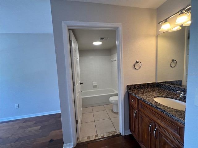7320 Westpointe Blvd Unit 531, Orlando, FL 32835 - bathroom featuring vanity, toilet, washtub / shower combination, and baseboards