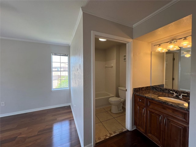 7320 Westpointe Blvd Unit 531, Orlando, FL 32835 - bathroom with crown molding, toilet, vanity, wood finished floors, and  shower combination
