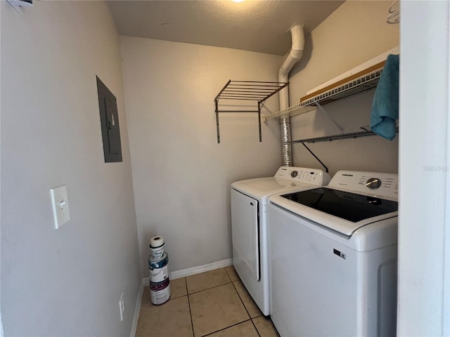 7320 Westpointe Blvd Unit 531, Orlando, FL 32835 - washroom featuring electric panel, washer and clothes dryer, light tile patterned floors, and baseboards