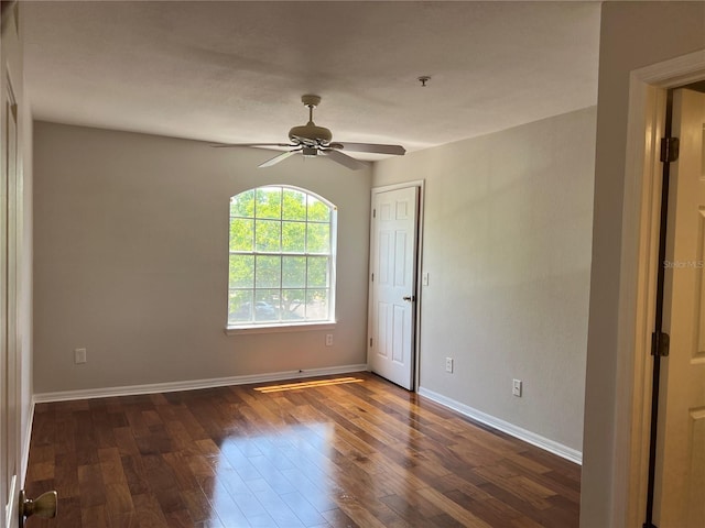 7320 Westpointe Blvd Unit 531, Orlando, FL 32835 - unfurnished room with a ceiling fan, dark wood-style floors, baseboards, and a pendent fire sprinkler