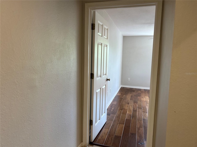 7320 Westpointe Blvd Unit 531, Orlando, FL 32835 - hallway with dark wood-style flooring, baseboards, and a textured wall