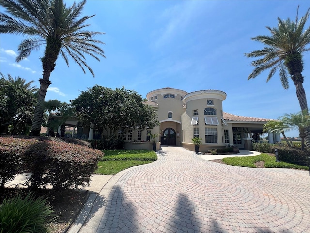 7320 Westpointe Blvd Unit 531, Orlando, FL 32835 - mediterranean / spanish-style home featuring stucco siding and curved driveway