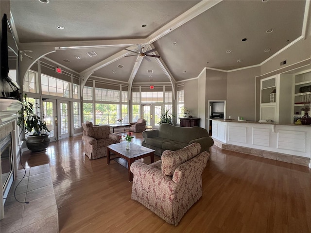 7320 Westpointe Blvd Unit 531, Orlando, FL 32835 - living area featuring high vaulted ceiling, a ceiling fan, beam ceiling, light wood-style floors, and french doors