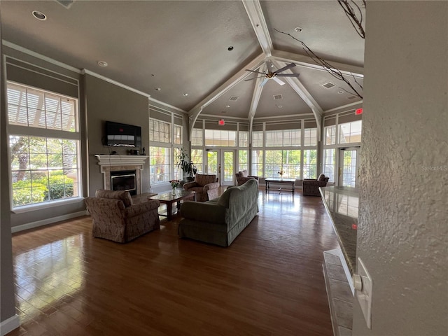 7320 Westpointe Blvd Unit 531, Orlando, FL 32835 - living room with beamed ceiling, high vaulted ceiling, a glass covered fireplace, ceiling fan, and wood finished floors